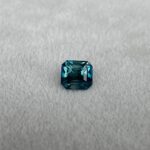 1.26 carat teal sapphire gemstone with vibrant hues of blue and green, showcasing its stunning color and clarity.